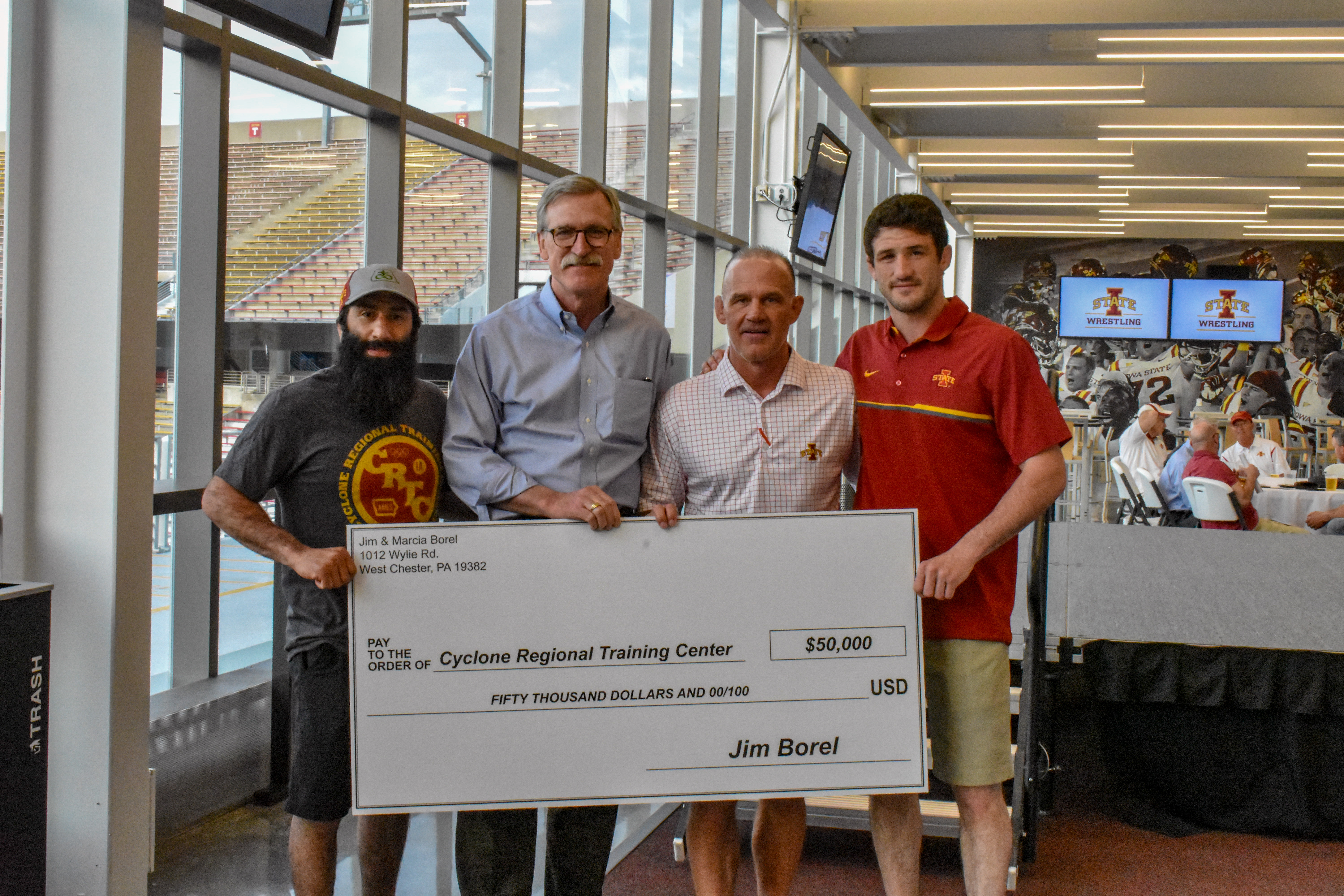 Group of Supporters presenting Coach Kevin Dresser with a $50,000 Checker
